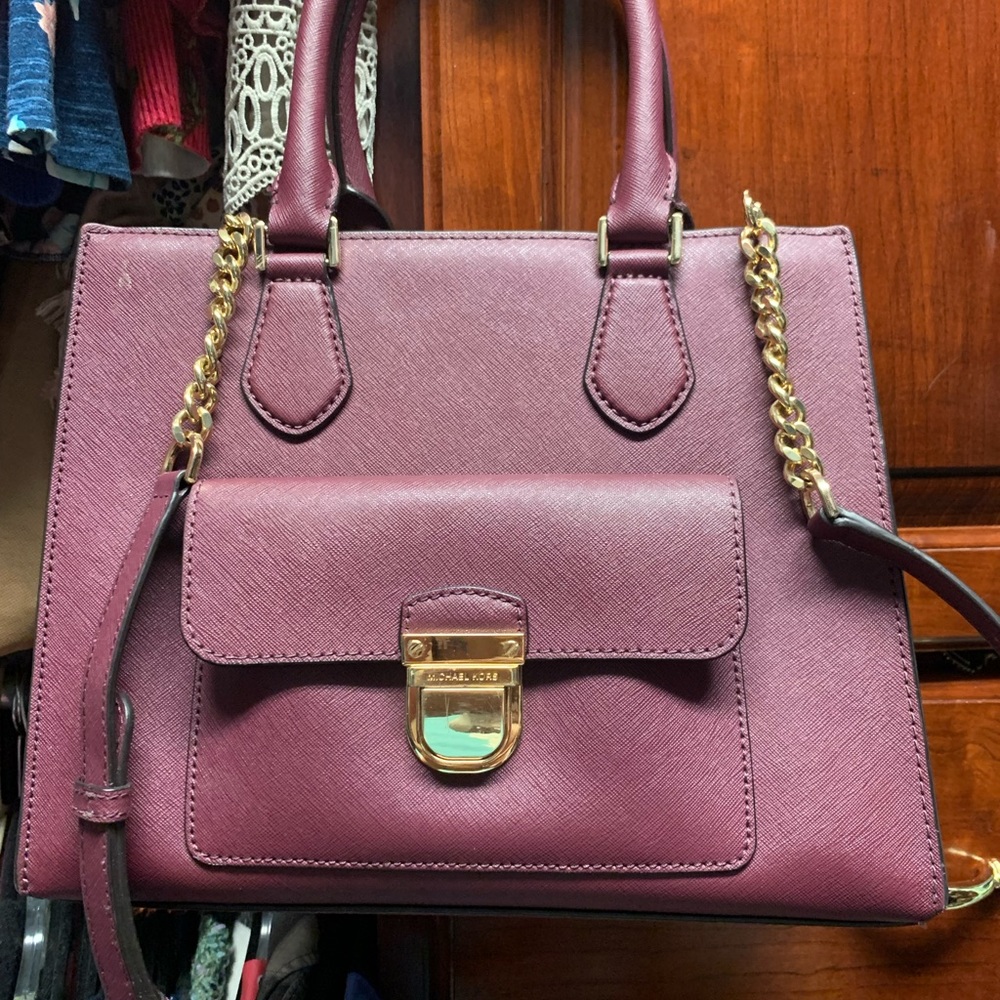 Michael Kors burgundy purse with handles or strap trimmed in gold